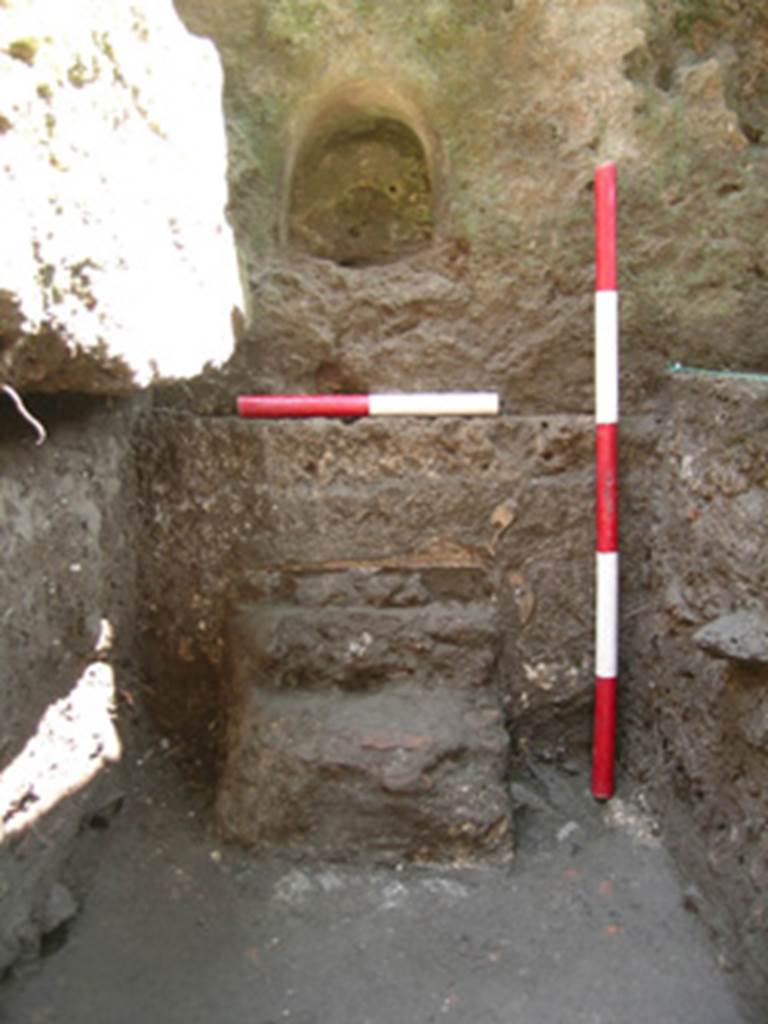 The buried altar under the small niche.