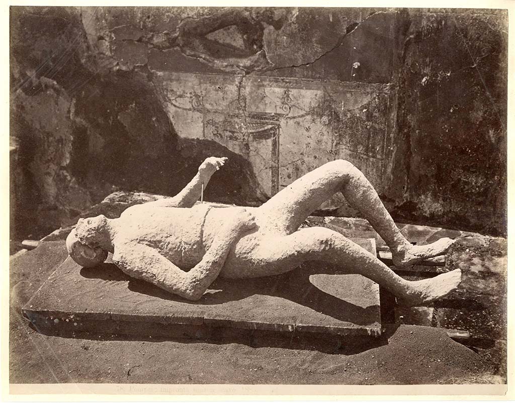 Victim numbered 11, described as “The Emaciated Child”, photographed by Giorgio Sommer in 1882. Photo courtesy of Eugene Dwyer.
VIII.5.39 Pompeii. Plaster-cast of an impression of a boy found on 24th January 1882, around 12 feet (4 metres) above the ancient ground level. 
Also found nearby was a skeleton of a woman, but only her arm was successfully cast. 
On her arm were two gold bracelets, and on her hand were two gold rings. 
It is conjectured that she was his mother, and that he was infirm and being helped from an upper window when the surge hit Pompeii.  
See Dwyer, E., 2010. Pompeii’s Living Statues. University of Michigan Press. (pp. 98 to 103).
See Notizie degli Scavi di Antichità, 1882, p.280: See BdI. 1884, pp126 sgg.
