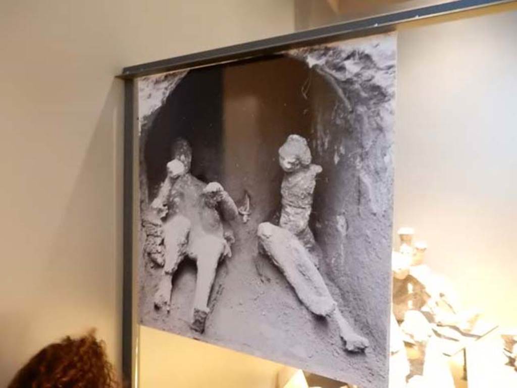 VI.17.42, Pompeii, May 2018. Archive photo of the finding of some of the fugitives also showing the golden bracelet. Photo courtesy of Buzz Ferebee.
