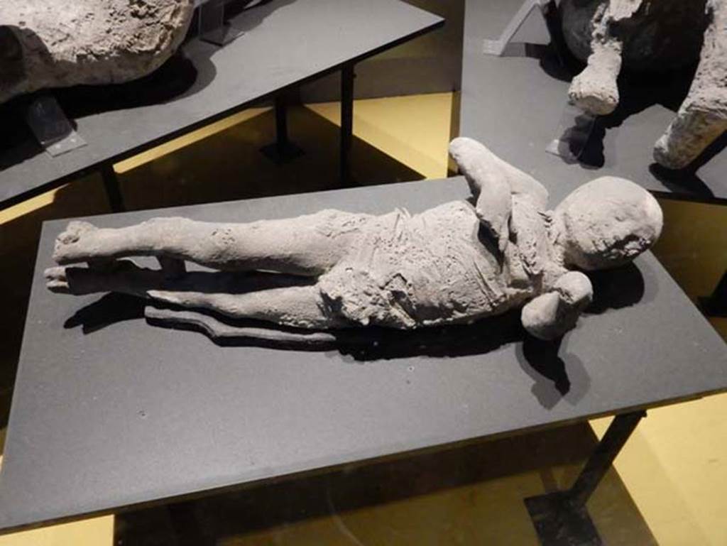 VI.17.42, Pompeii. Victim 53. May 2018. Plaster cast of young child found in the corridor leading to the garden area.
Photo courtesy of Buzz Ferebee.
According to Estelle Lazer et al, "The bone development of the skull suggests an age between one and three years and less than five. 
The likely age at death would be between two and three and a half years, with the evidence indicating an age closer to three years.
The overall evidence suggests an age consistent with about three years in a modern Western individual.
At present there is insufficient evidence to make an unequivocal attribution of sex of this individual from gross inspection of the skeletal evidence.
The DNA evidence does suggest that this individual was a male.".
See Lazer E., et al. 2020. Inside the Casts of the Pompeian Victims: Results from the First Season of the Pompeii Cast Project In 2015. Papers of the British School at Rome.
