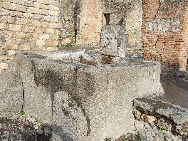 Fountain outside I.4.15 on Via Stabiana. Pre-1943. 
Looking north-east. Photo by Tatiana Warscher.
See Warscher, T. Codex Topographicus Pompeianus, IX.1. (1943), Swedish Institute, Rome. (no.66).
