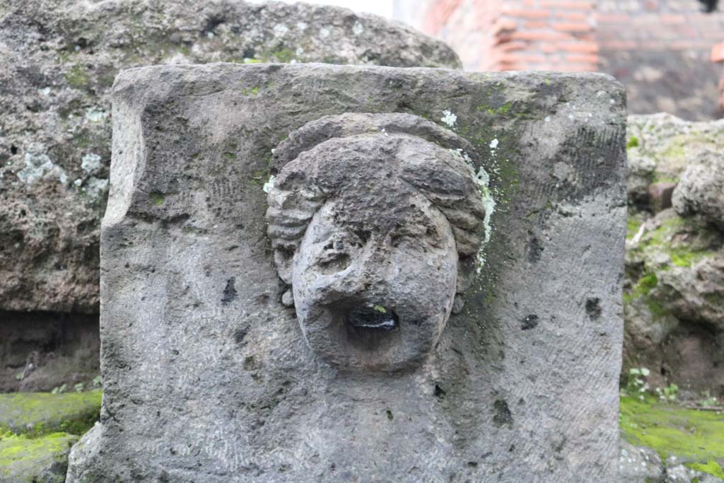 Fountain outside I.13.10, possibly representing head of Juno or a nymph, with diadem. December 2018. Photo courtesy of Aude Durand.

