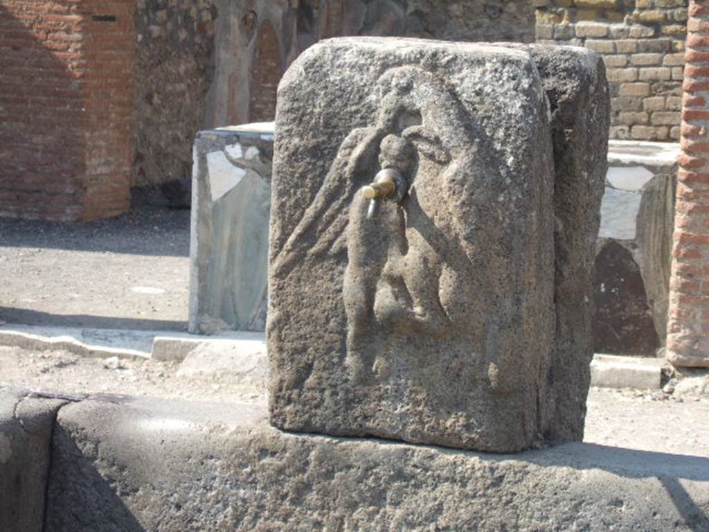 Fountain outside VI.3.20 September 2005. Bas-relief of an eagle holding a hare in its talons.