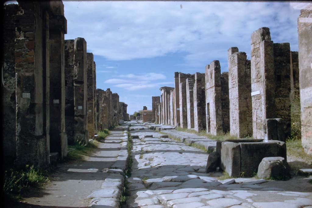 Fountain outside VI.13.7. Via della Fortuna, Pompeii. November 1958. 
Looking west between VII.4 and VI.13 towards junction with Via dell Foro, and Arch on Via Di Mercurio, with VI.13, on right. 
Photo courtesy of Rick Bauer.

