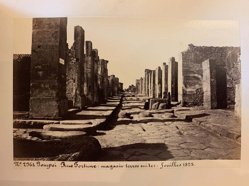 Fountain outside VI.13.7.  Via della Fortuna between VII.4 and VI.13, looking west. 
From an album of Michele Amodio dated 1874, entitled “Pompei, destroyed on 23 November 79, discovered in 1745”. 
Photo courtesy of Rick Bauer.
