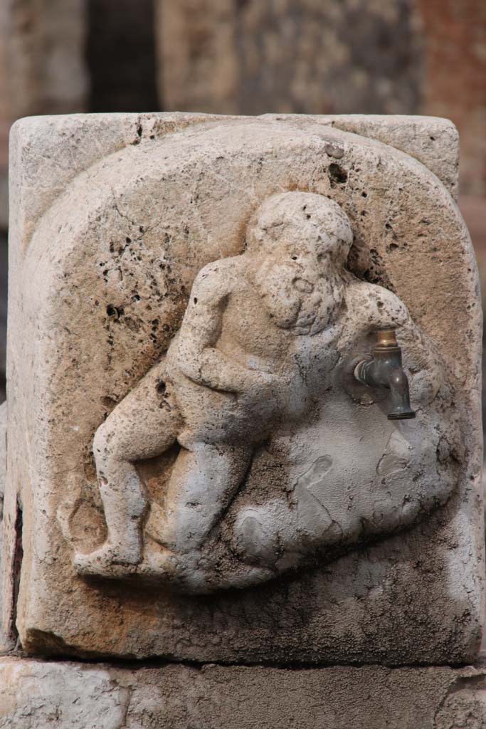 Fountain outside VI.14.17, Pompeii. October 2020. Detail of marble relief of Silenus on pilaster of fountain.
Photo courtesy of Klaus Heese.
