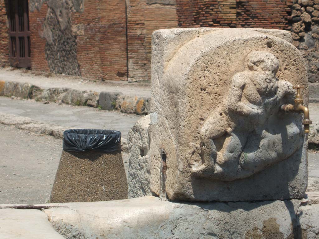 Fountain outside VI.14.17, Pompeii. December 2018. 
Detail of marble relief of Silenus on pilaster of fountain. Photo courtesy of Aude Durand.
