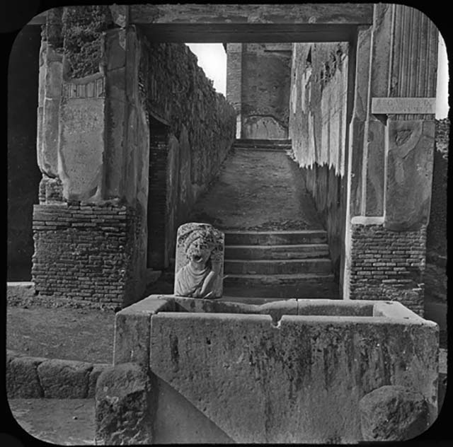 VII.9.67 Steps to rear of Eumachia’s Building showing  fountain and Vicolo di Eumachia, looking north. Old undated photograph courtesy of the Society of Antiquaries, Fox Collection.

