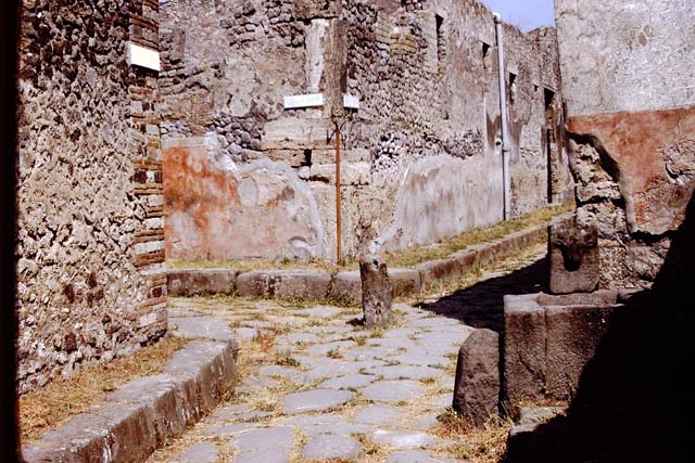 Fountain on Vicolo di Tesmo outside IX.7.17. 1972. 
Looking north to junction with Vicolo di Balbo, on the left, and IX.7, on the right at rear of fountain. Photo by Stanley A. Jashemski. 
Source: The Wilhelmina and Stanley A. Jashemski archive in the University of Maryland Library, Special Collections (See collection page) and made available under the Creative Commons Attribution-Non-Commercial License v.4. See Licence and use details.
J72f0112

