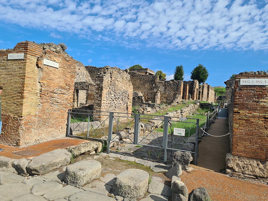 I.2 Pompeii, on left. October 2024. Vicolo del Conciapelle looking east. North side of I.1.9, on right. Photo courtesy of Klaus Heese.