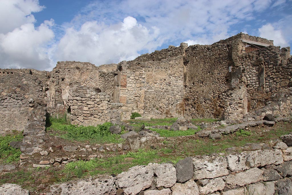 I.2.3 Pompeii. October 2024. 
Looking north towards east wall of garden area, centre right.
On the right is the east wall of two rooms, one a storeroom and one a sacrarium. Photo courtesy of Klaus Heese.

