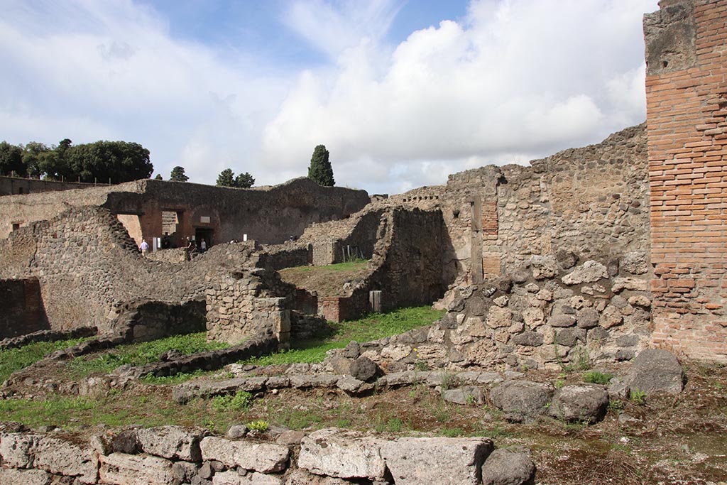 I.2.3 Pompeii, in centre and on right, with rear of I.2.1, on left. October 2024. Looking north-west. Photo courtesy of Klaus Heese.