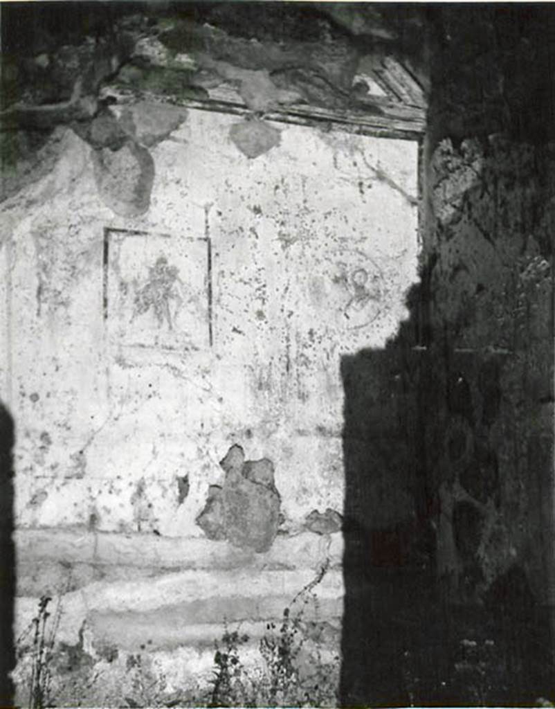 I.2.3 Pompeii. 1935 photo by Tatiana Warscher.
Looking towards north wall of cubiculum, with central painting of Poliphemus and Galatea.
Warscher described this as, by quoting Sogliano - 
“I.2.3 Nel cubicolo (a destra?) erano tre quadretti; ne abbiamo solamente uno con Polifemo e Galatea. L’Arianna abbandonata è distrutta. Si vedono ancora le traccie dei medaglioni, uno coi busti di Marte e Venere. 

She also quoted Mau, from Bull. Inst. 1874, p.202-3 –
“Le tre pareti di detta camera sono divise ciascuna in tre scompartimenti, ne’quali in mezzo a ciascuna parete vi è un piccolo quadro, sui due lati medaglioni con figure visibili sino al petto, circondati da ghirlande. In mezzo al muro di fondo abbiamo un quadro compagno di quello descritto dall’Helbig (no.1052) e spiegato per Polifemo e Galatea. 
Qui Polifemo, nudo sta seduto, tenendo sulla coscia Galatea: si guardano affettuosamente negli occhi. Accante sta un ariete. Nel medaglione a sinistra una donna con capelli biondi e svolazzanti, armata di elmo e lancia, si rivolge a destra verso un uomo imberbe, che come pare le parla nell’orecchio.  Nel madaglione a destra vediamo una donna con capello, turcasso e due lancie; sopra la sua spalla destra è visibile la testa d’un uomo imberbe e armato d’una lancia, che la guarda attentamente e sembra parlare; ella invece guarda dalla parte opposta con aria scontenta, se non m’inganna l’esecuzione trascurata.  A sinistra si scorge come un vaso sopra una base.

In mezzo alla parete destra nel primo piano sta sdraiata Arianna, appoggiandosi sul braccio destro; nel fondo si scorge la nave.  Nel medaglione a sinistra vi è una testa di baccante, e a destra di essa un vaso ed un tirso sopra un base.  In quello a destra si vede una testa muliebre ed un’altra testa più piccola, di cui non si distinguono I dettagli.
See Warscher T., 1935. Codex Topographicus Pompeianus: Regio I.2. (no.6), Rome: DAIR, whose copyright it remains.   

(translation: from Sogliano - “I.2.3 In the cubiculum (on the right?) were three paintings; of them we have only the one with Polyphemus and Galatea. The abandoned Ariadne was destroyed. You could still see the traces of medallions, one with the busts of Mars and Venus”.
from Mau – “The three walls of the room are each divided into three compartments, in the middle of which on each wall was a small picture, on either side of which were medallions with figures, surrounded by garlands.  In the middle of the rear wall we have a companion painting of that described by Helbig (no.1052) and explained as Polyphemus and Galatea. Here was nude Polyphemus, sitting holding onto the thigh of Galatea, looking lovingly into each others eyes.  Nearby was a ram. In the medallion on the left, we could see a flying figure of a woman with blonde hair, armed with helmet and spear, turning to the right towards a beardless man, who seemed to be speaking into her ear. In the medallion on the right, we could see a woman with hair, a quiver and two lances: visible above her right shoulder was the head of a beardless man also armed with a lance, looking attentively at her and seeming to speak; she instead looked towards the opposite side with an unhappy air, if we are not mistaken. On the left, one could see a pot on a base.

In the middle of the right wall in the foreground was Ariadne, lying down leaning on her right arm; in the background you could see the ship.   In the medallion on the left there was the head of a bacchante, and to the right of it a vase and a thyrus on a base.   
On the right you could see a head of a woman and another smaller head, but of these one couldn’t distinguish the details.”
