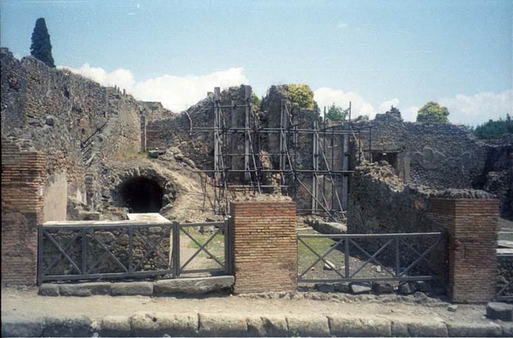 I.2.12 Pompeii. July 2011. Looking east to entrance doorway (on right) from Via Stabiana. Photo courtesy of Rick Bauer.
Warscher described this, quoting Fiorelli, as  “I.2.12/13 – due taberne aventi comunicazione tra loro.  Il podio è rivestito di marmi.  Qui l’insula è delimitata dalla via secunda, sulla quale si aprono gl’ingressi di altre abitazioni”.
See Warscher T., 1935. Codex Topographicus Pompeianus: Regio I.2. Rome: DAIR.
(translation: "I. 2.12/13 - two workshops having communication between them.  The podium was covered with marble.   Here the insula is bounded by via secunda, on which opens the entrances of other dwellings.")
