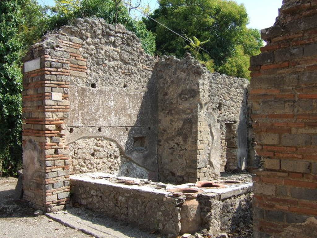 I.2.18 Pompeii. September 2005. Entrance. According to Della Corte, the bar was held by a greek named, Demetrios.  Painted graffiti was found on the left side of the entrance of number 18, underneath a big phallus leaning from the external wall:

L(ucium)  C(eium)  S(ecundum)  II vir(um)  o(ro)  v(os)  f(aciatis)
Demetrius rog.     [CIL IV 2993z].      

Demetrius (rogat)     [CIL IV 2993z, a]

On the right side of the entrance, a painted graffito was found with the name of his companion.  She was named Helpis, also greek, but possibly of african descent or brown in colour, as she was described by the name of Afra.  

L(ucium)  Ceium  Secundum  II vir(um)  o(ro)  v(os)  f(aciatis)
Helpis Afra rog(at)      [CIL IV 2993z, c]

See Della Corte, M., 1965.  Case ed Abitanti di Pompei. Napoli: Fausto Fiorentino. (p. 272)
