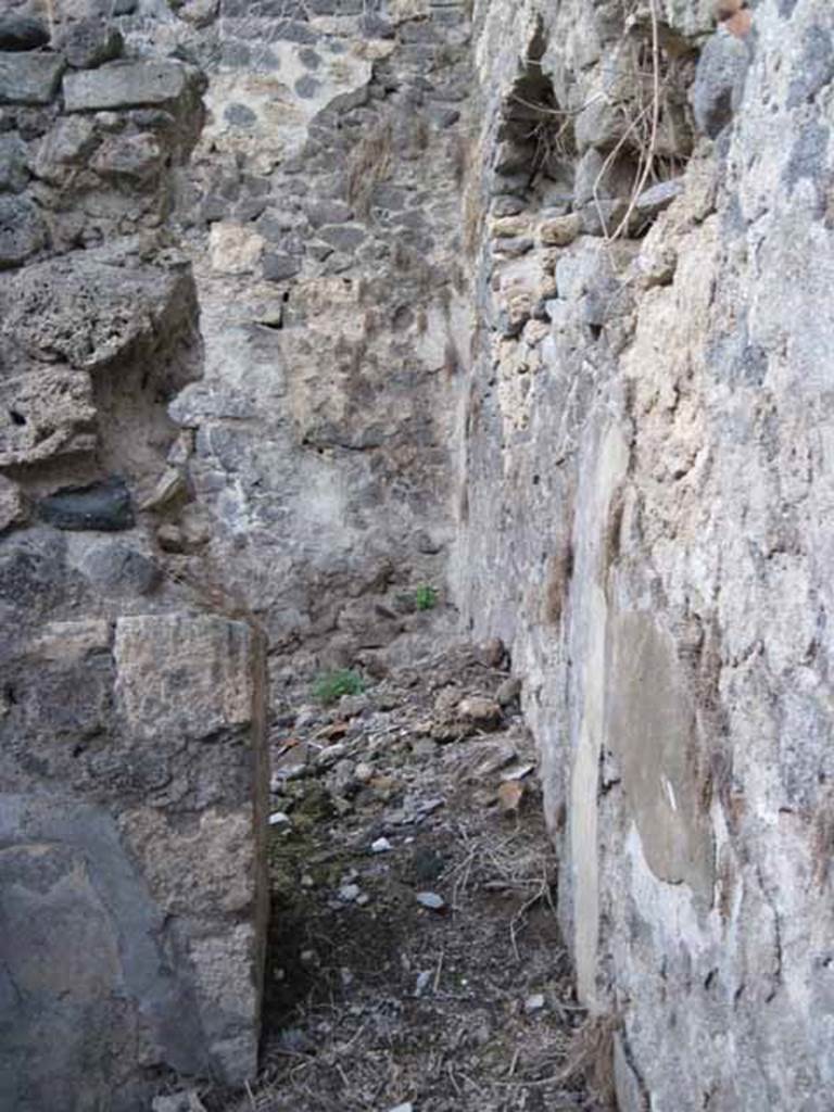 I.2.24 Pompeii. September 2010. North wall with doorway into second room on north. Photo courtesy of Drew Baker
