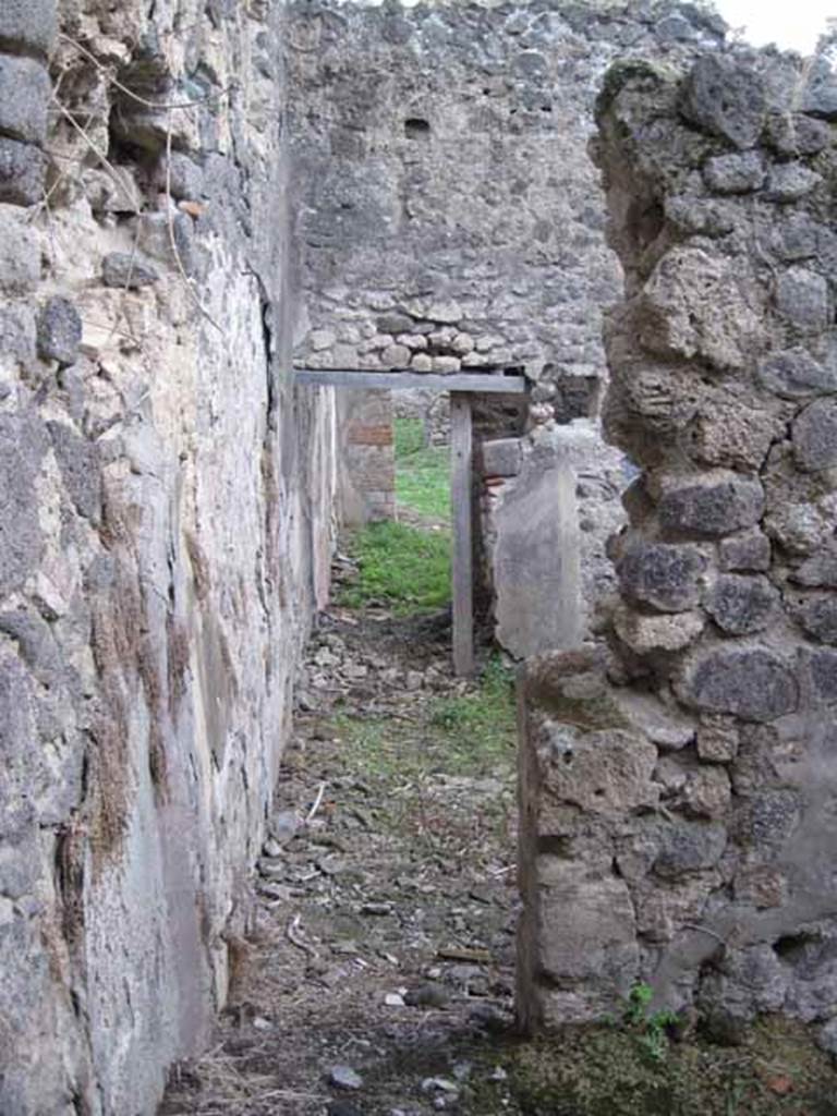 I.2.24 Pompeii. September 2010. Looking south through doorway into corridor, from room on north side. Photo courtesy of Drew Baker.
