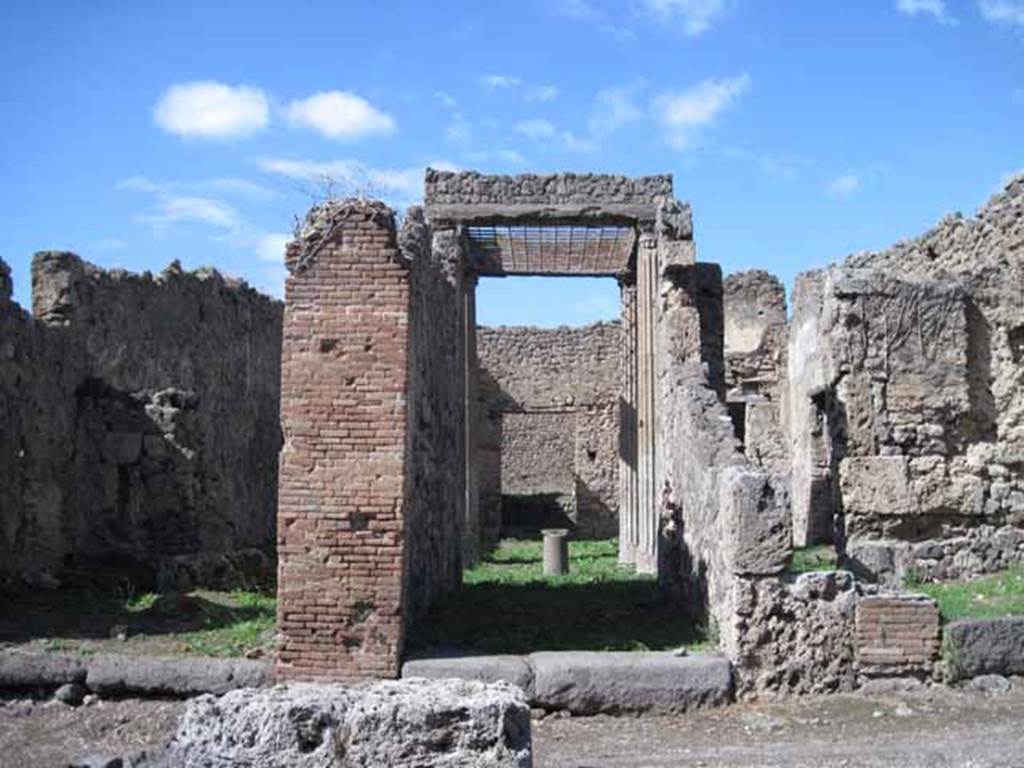 I.2.28 Pompeii. September 2010. Looking north to entrance doorway with step of Vesuvian stone, from across Vicolo del Conciapelle. Photo courtesy of Drew Baker.
