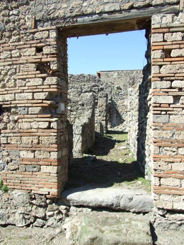 I.3.30 Pompeii. March 2009. Entrance doorway, looking north along entrance corridor.
According to Warscher, quoting Fiorelli, this was a house in the southern roadway known as Via Secunda. The entrance corridor was bordered by the kitchen, which was near a staircase, after which was the lararium painted with the Lares with rhyton and situla, now completely faded. In the storeroom a painted graffito was found –
XV K AVGVSTAS
PARTISCA ESERNIE
FVIT            (CIL IV 3388)
See Warscher, T, 1935: Codex Topographicus Pompejanus, Regio I, 3: DAI,  Rome.  
