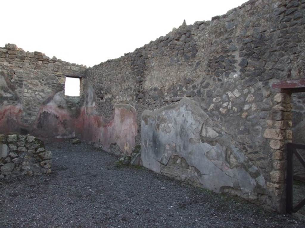 I.4.23 Pompeii. December 2007. Looking south-west. The window in the rear room overlooks the atrium of I.4.22.  The doorway in the west wall has access to the fauces of I.4.22.

