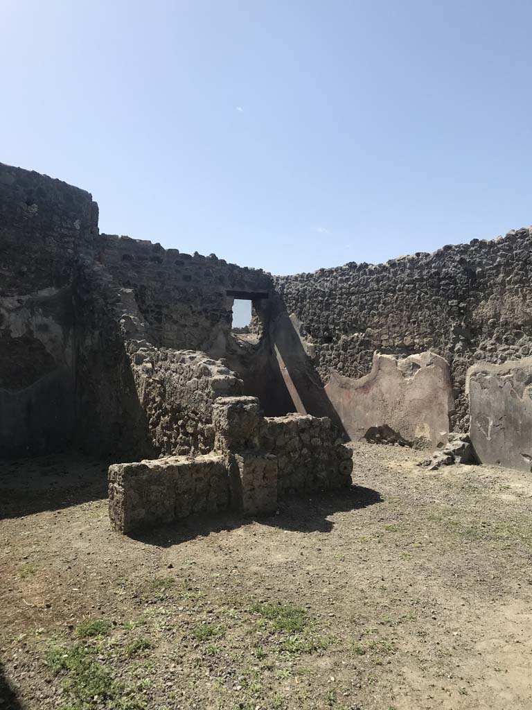 I.4.24 Pompeii. April 2019. Looking across shop to south-west corner.
Photo courtesy of Rick Bauer.
