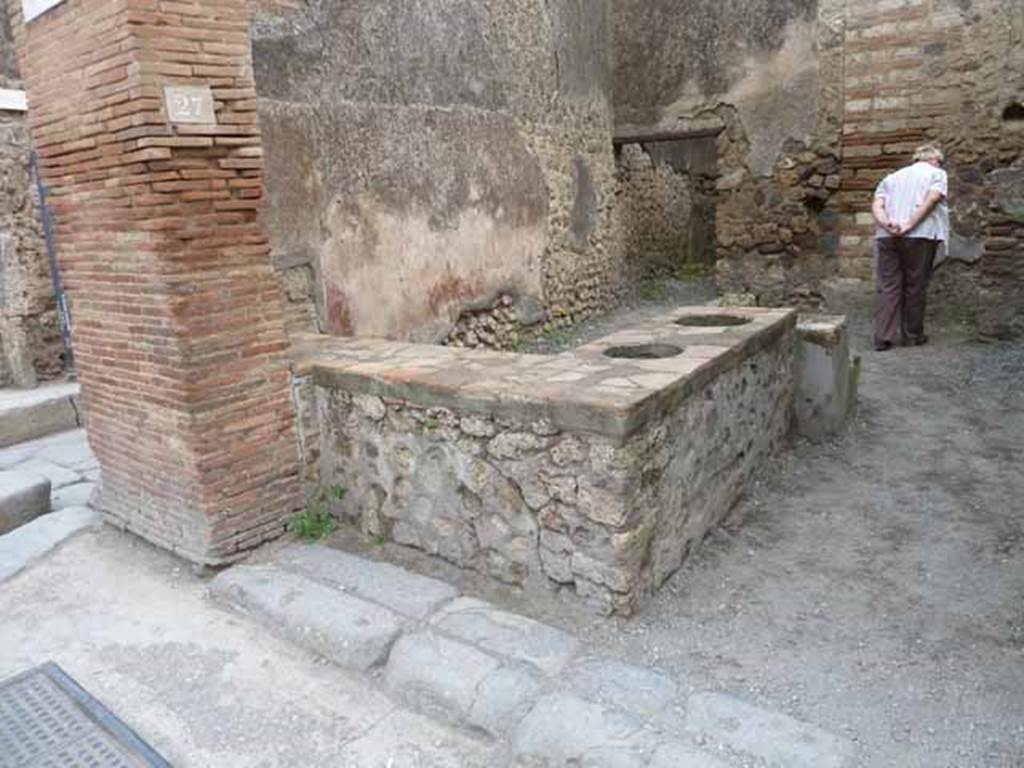 I.4.27 Pompeii. May 2010. Looking south-east across counter towards door to rear room.