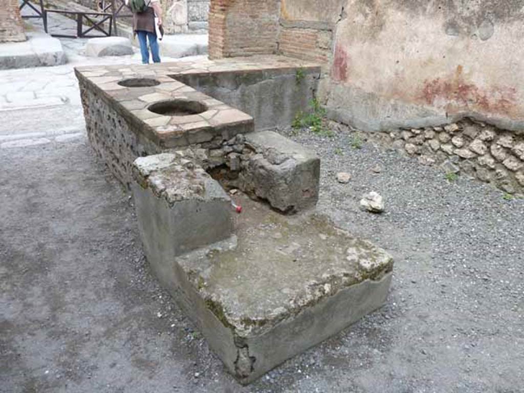 I.4.27 Pompeii. May 2010. Rear of hearth, looking to front of bar or sales-room.
