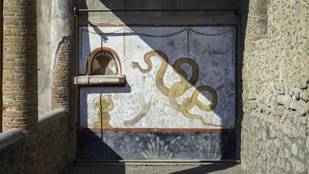 I.6.2 Pompeii. August 2021. Painted lararium on west wall near portico. Photo courtesy of Robert Hanson.