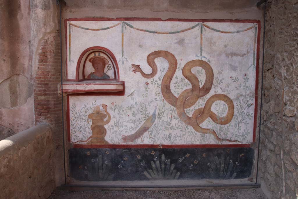 I.6.2 Pompeii. September 2019. Painted lararium on west wall near portico. Photo courtesy of Klaus Heese