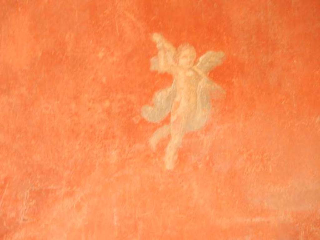 I.6.7 Pompeii. May 2016. Detail of painted flying cupid from south end of east wall.   Photo courtesy of Buzz Ferebee. 
