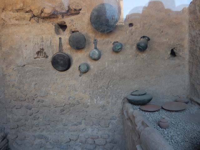I.6.7 Pompeii. May 2017. Household utensils displayed on south wall of kitchen area. 
Photo courtesy of Buzz Ferebee.

