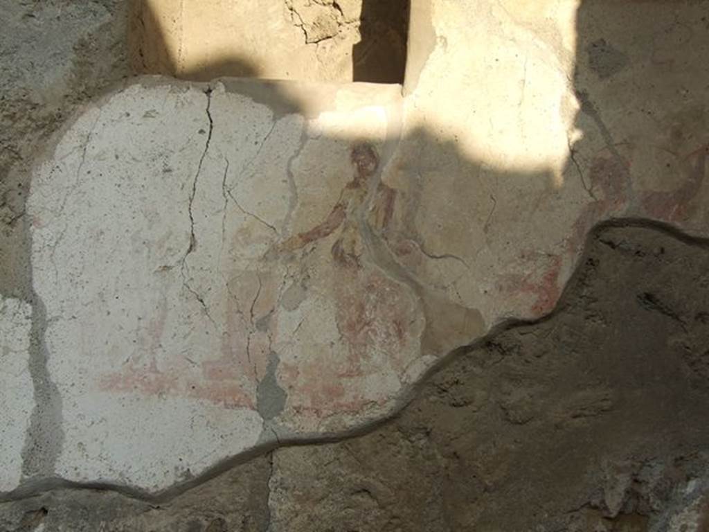 I.7.11 Pompeii. December 2006. Remains of Lararium on east side of atrium belonging to original house I.7.10. According to Boyce, immediately below the niche was the familiar sacrificial scene, flanked by a figure of a Lar on each side. (Only part of the remains of the Lar on the right of the Genius, is visible today)
