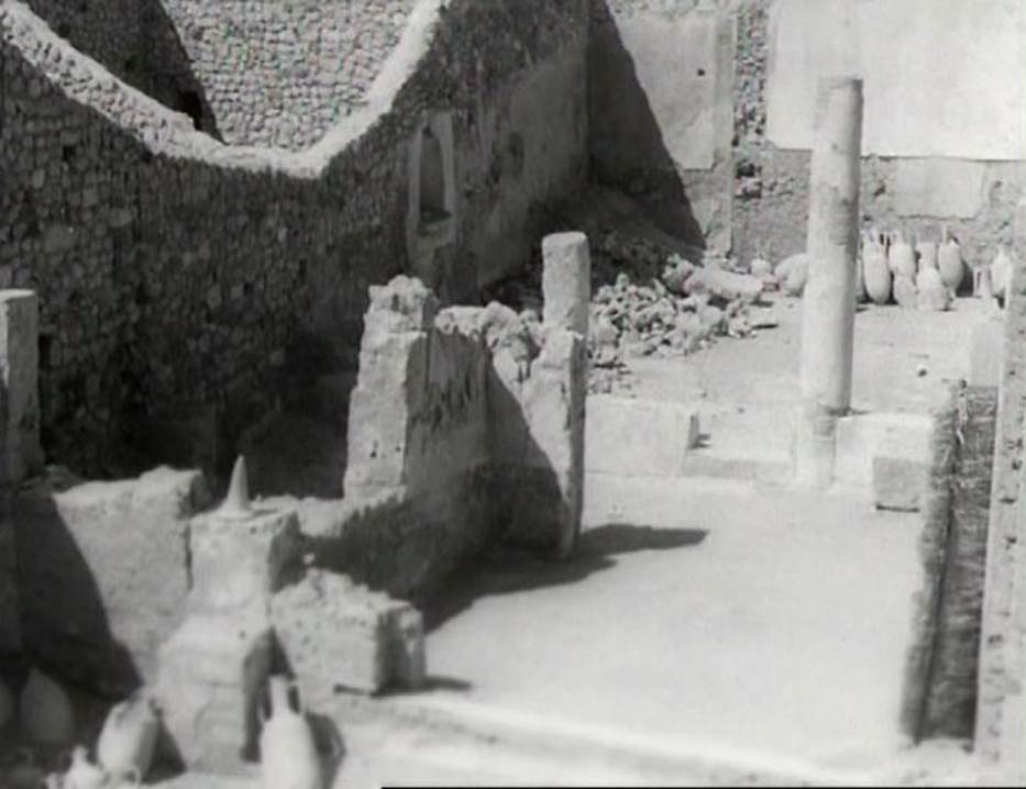 I.9.12 Pompeii. Photo taken in 1954, shortly after excavation. 
Looking north through tablinum towards garden area/peristyle. Note the lararium niche on the west wall.
