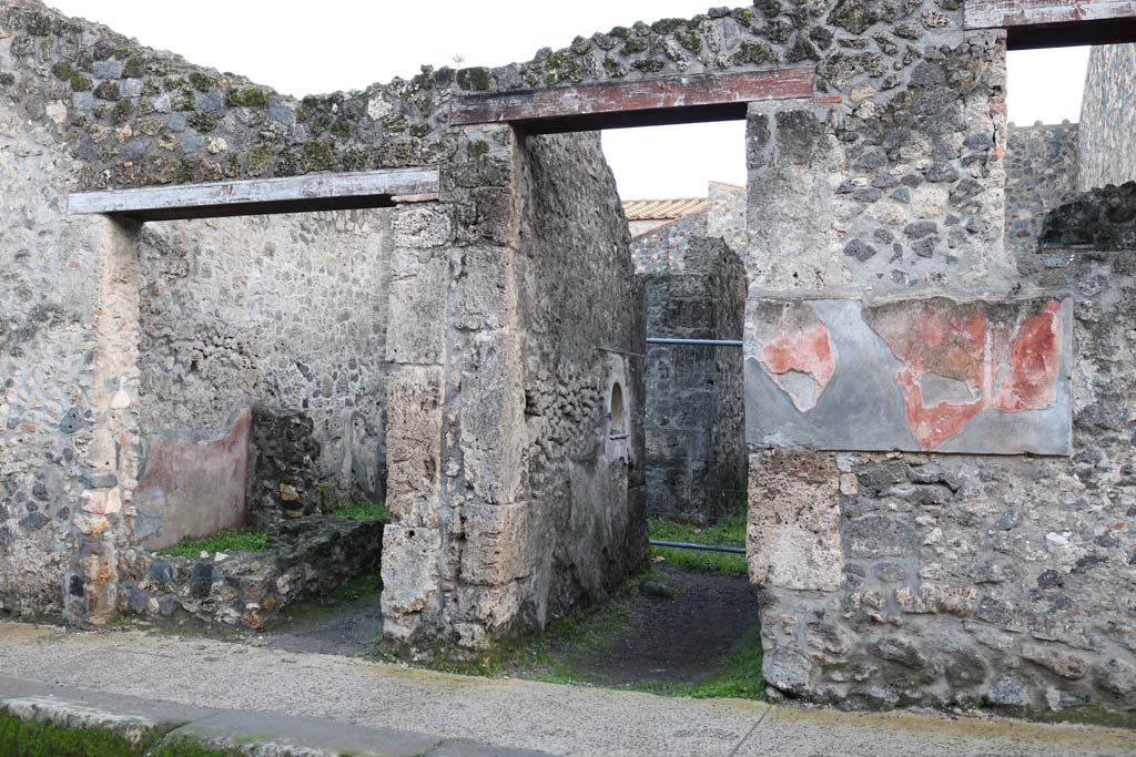 I.10.2 (on left) and I.10.3 Pompeii, (in centre). December 2018.  
Looking south on Vicolo del Menandro towards entrance doorways. Photo courtesy of Aude Durand.

