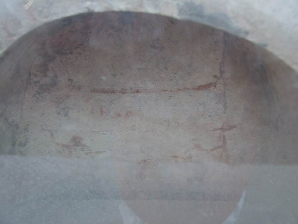 I.10.3 Pompeii. March 2009. 
Upper part of niche on east wall of fauces, red garland and remains of an inscription “Felix aeris IV as, Florus X.”. 
