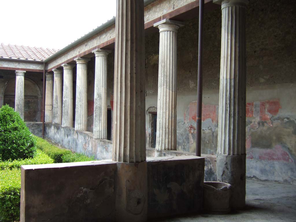I.10.4 Pompeii. May 2006. West portico of peristyle. Looking towards entrance to baths in west wall.