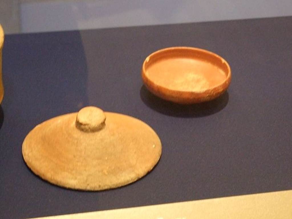 I.10.4 Pompeii. Found on 31 July 1931 in corridor P1. Ceramic cover (On the left). SAP inventory 4839.  Photographed at “A Day in Pompeii” exhibition at Melbourne Museum. September 2009.