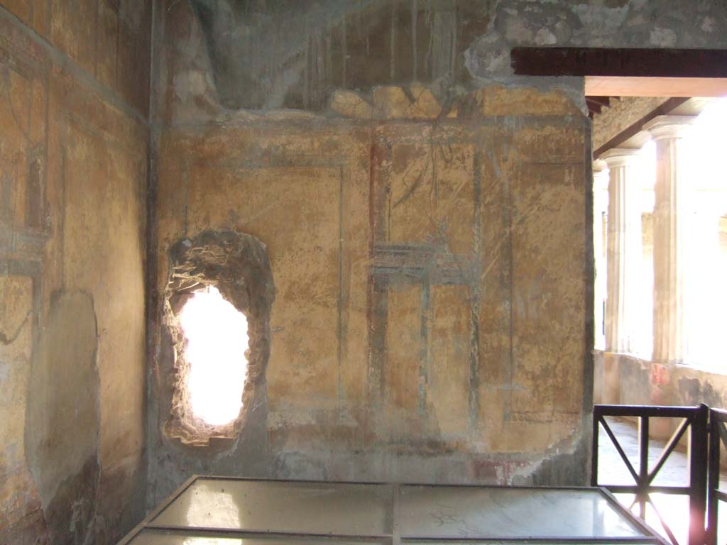 I.10.4 Pompeii. May 2006. 
Room 19, west wall. One of the holes, presumably made by the mattock and pickaxe found in this room, can be seen.
