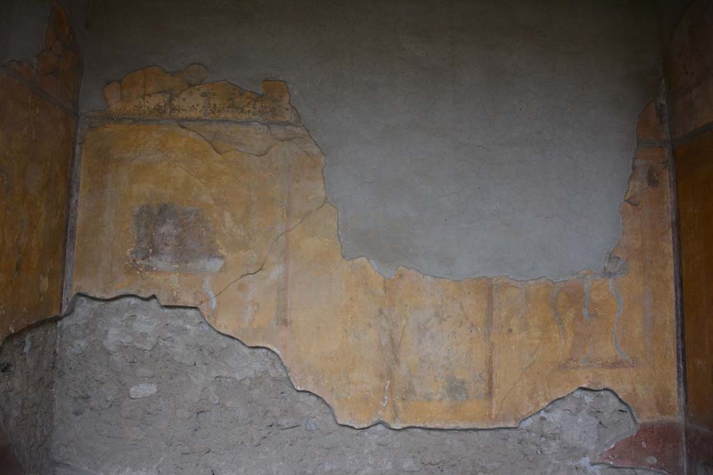 I.10.4 Pompeii. October 2017. Alcove 23, looking towards south wall.
Foto Annette Haug, ERC Grant 681269 DCOR.
Alcove 23, south wall, 
painted masks, on left, with possibly Bacchus sitting on a chair with robe covering his legs in central panel, and painted table, on right.
See Kuivalainen, I., 2021. The Portrayal of Pompeian Bacchus. Commentationes Humanarum Litterarum 140. Helsinki: Finnish Society of Sciences and Letters, (p.104, B17).

