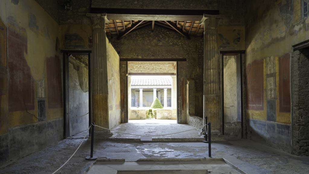 I.10.4 Pompeii. August 2021. 
Looking south across impluvium in atrium towards the tablinum, room 8. Photo courtesy of Robert Hanson.
A wood and bronze triclinium bed was found in Room 8, the tablinum, on 18th August 1928.



