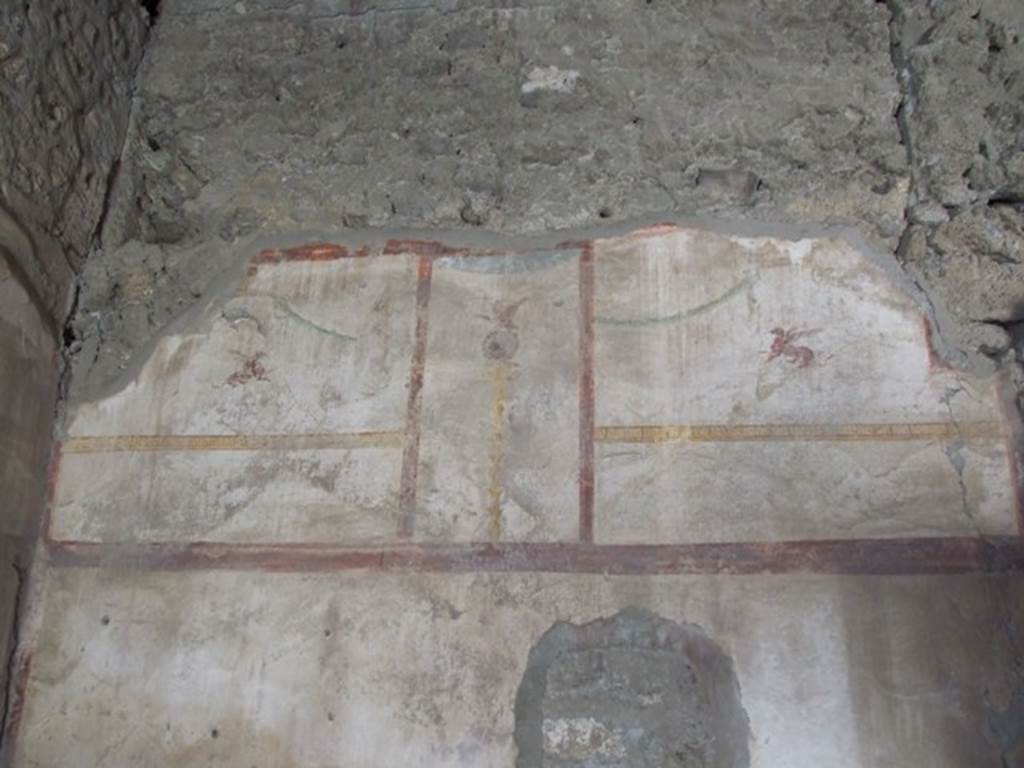 I.10.7 Pompeii. March 2009. Room 2, remains of painted decoration on west wall of cubiculum. 