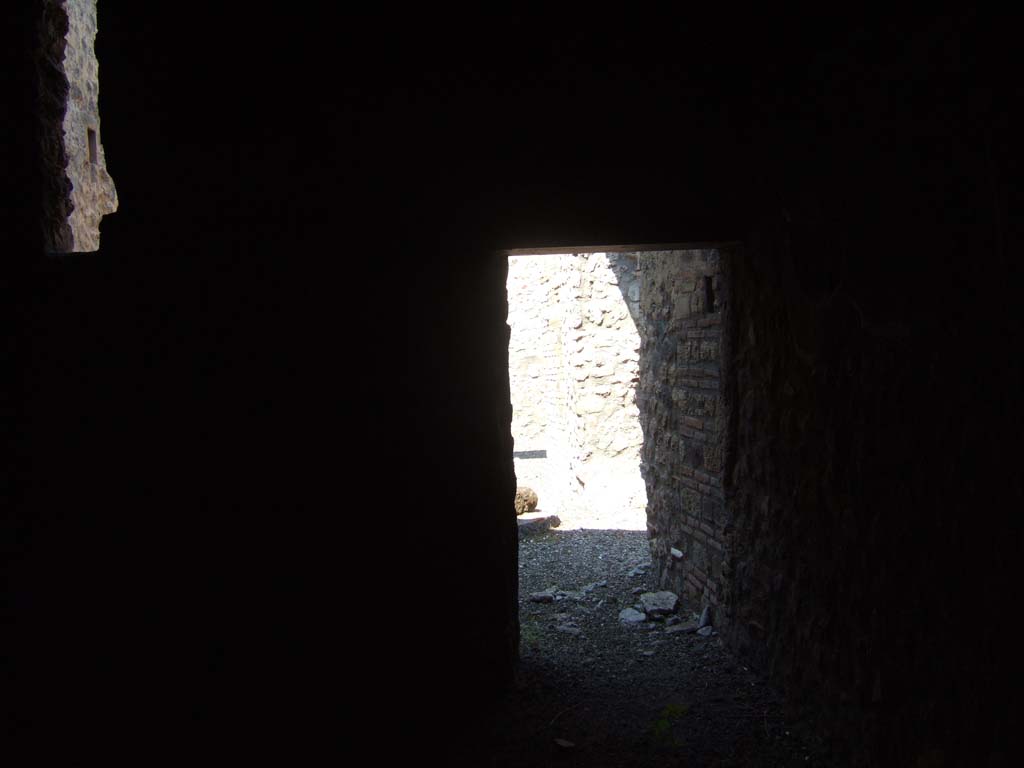 I.10.14 Pompeii. September 2005. View through small window in exterior south wall into latrine room. Looking north.