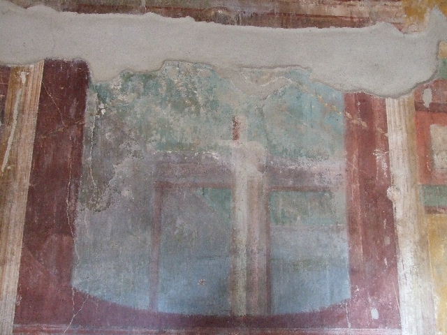 I.11.14 Pompeii. December 2006. Detail of architectural painting in centre panel of east wall of oecus