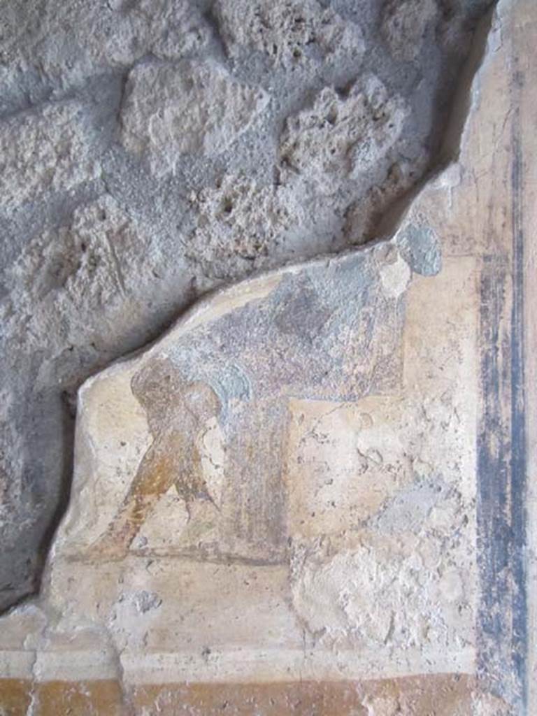 I.11.15 Pompeii. April 2012. Room 13, west wall with detail of remains of wall painting with seated figure dressed in blue cloak. Photo courtesy of Marina Fuxa.
