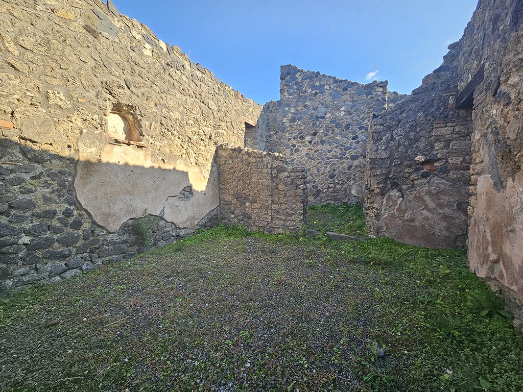 I.13.5 Pompeii. November 2024. Looking towards south wall with doorway to rear room, in centre. Photo courtesy of Annette Haug.