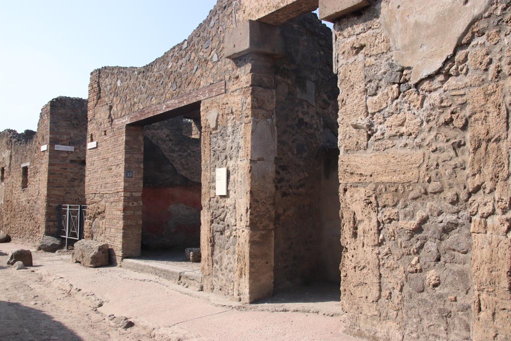 I.13.12 Pompeii. October 2023. Looking west along north side of Via di Castricio, with entrance doorway, centre right. Photo courtesy of Klaus Heese.