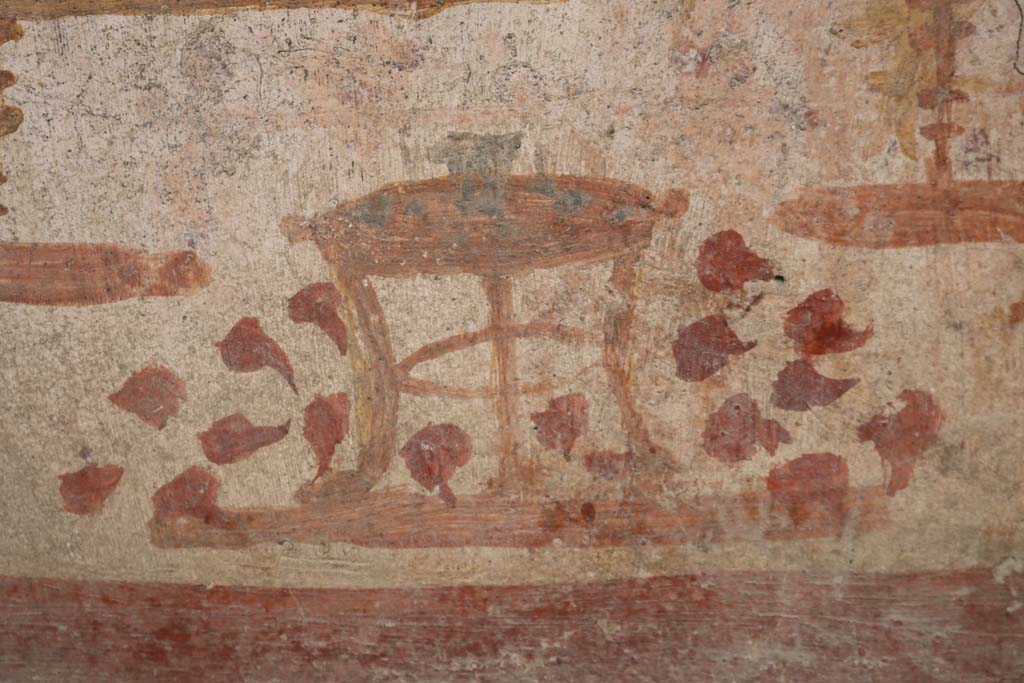 I.14.7 Pompeii. December 2018. Detail of three-legged table with bowl of fruit from niche lararium on west wall. Photo courtesy of Aude Durand.