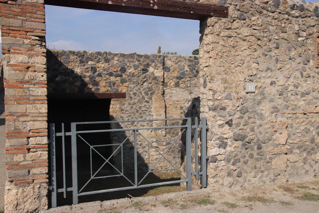 I.14.11 Pompeii. October 2023. Entrance doorway on north side of Via della Palestra. Photo courtesy of Klaus Heese.