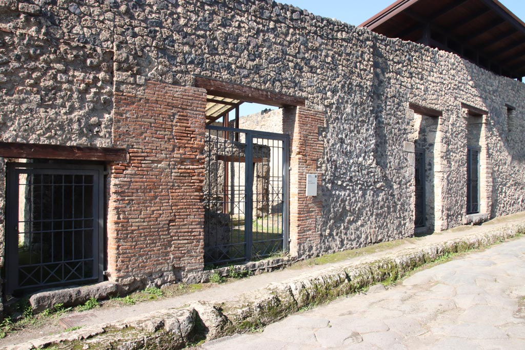 I.20.1, on left, followed by I.20.2, in centre, Pompeii October 2022. 
Looking towards entrance doorways on west side of Via di Nocera. Photo courtesy of Klaus Heese.
