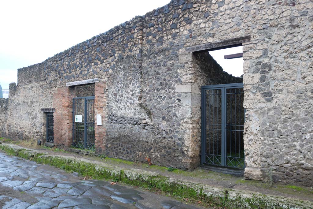 I.20.3, Pompeii, on right, I.20.1, on left, I.20.2, in centre. December 2018. 
Looking towards doorways on west side of Via di Nocera. Photo courtesy of Aude Durand.
